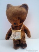 A nice old retro teddy bear with a small Hungarian book with pictures around his neck