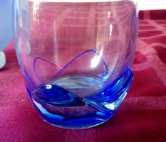 Special glass vase with blue flower petals at the bottom