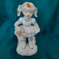 Porcelain girl with a watering can