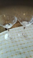 A pair of antique crystal glasses with a small charm