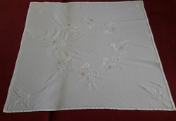 Embroidered tablecloth with perforated decoration
