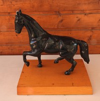 A large horse statue on a wooden pedestal