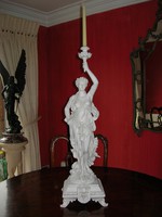 Lady holding marble statue with candlestick