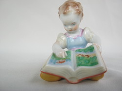 Retro ... Little girl looking at herend porcelain picture book