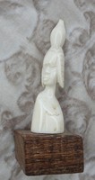 Antique oriental bone sculpture on wooden pedestal