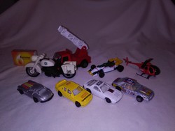 Eight match-box-style retro toy cars, motorcycles, helicopters, firefighters, ... Together