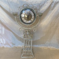 Antique metal candlestick with clock