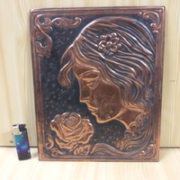 Bronze, copper female head with rose mural, wall decoration.