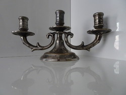 Three-pronged silver-plated candlestick.