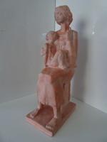 Beautiful terracotta statue of mother with her baby in beautiful gallery.