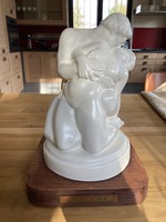 Porcelain coated sculpture with wooden pedestal