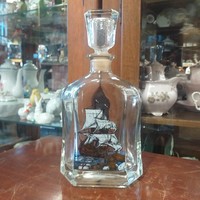 Liquor thick glass bottle with sailing decoration.