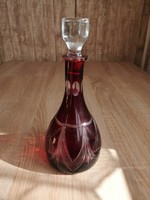 Lip crystal burgundy liqueur bottle with polished decoration.