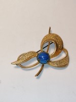 Antique gold colored brooch with blue glass (275)