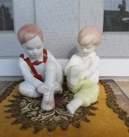 Aquincum, a pair of nipp figurines of a dressed-up child pulling on aquincum pants is a collector's item