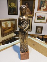 R. Kiss Lenke bronze girl with flowers on pedestal in gallery