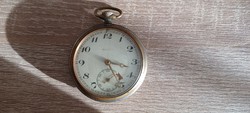 Old working antique pocket watch in worn condition