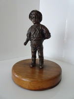 A beautiful bronze statue of a boy going to school in perfect condition.