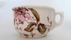 Old cup with thick-walled porcelain mug with floral cup