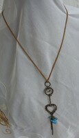 Double heart pendant necklace with blue hanging stones on leather strap