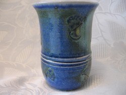 Retro fish sign in ceramic small blue vase in studio