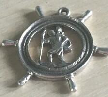 Saint Christopher, the patron saint of travelers, is marked with a silver pendant