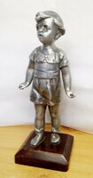 Tousled little girl with tin alloy sculpture on wooden pedestal. Piece for collection.