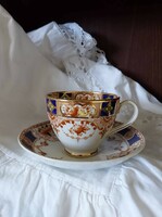 ​An antique English faience tea cup and saucer