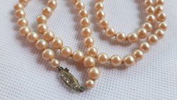 Vintage peach-colored tekla string of pearls with decorative clasp