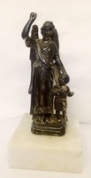 Children's guardian angel statue on a marble pedestal, antique small sculpture made of tin.