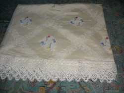 Cream-colored cross-stitch tablecloth