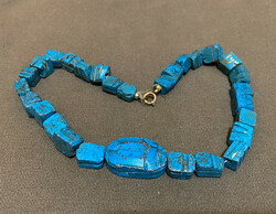 Egyptian ceramic necklace with gold clasp.