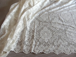 A dreamy lace curtain with a baroque pattern