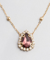 Drop-shaped, burgundy red crystal pendant, with small white crystals, gold-colored chain.