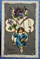 Antique embossed New Year greeting card little girl on a swing in 4-leaf clover ball violet