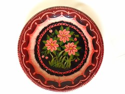 Old antique granite wall plate, home-painted with oil paint, with a floral pattern