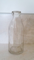 Old milk glass milk bottle with ribbed walls, stork pattern