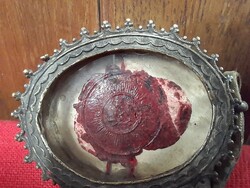 Old religious holy relic holder with wax seal.