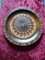 A wooden bowl with a burnt pattern