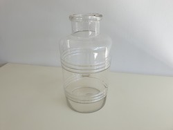 Old vintage mason jar in the shape of a 3 liter striped convex patterned barrel