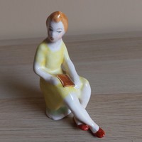 A rare collectible Bodrogkeresztúr ceramic figurine of a little girl with a book