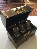 Perfume bottles in a wooden box decorated with copper