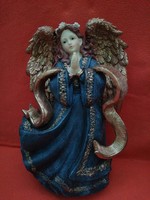 A large, charming, praying angel. Statue, figurine. Christmas, decoration.