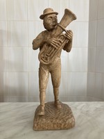 A figure of a trumpet musician carved from real wood