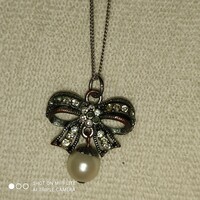 Silver pendant with marcasite stones on a silver chain and some sort of pearl pendant at the bottom