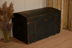 A chest with a rustic curved top