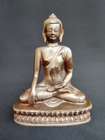 Antique seated Buddha on a lotus base.