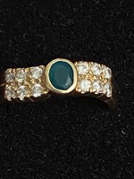 A wonderful wavy front 14k (585) gold ring with a green stone