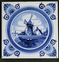 Old hand painted blue white delft tile landscape with windmill