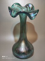 The iridescent frilled glass vase is gorgeous green